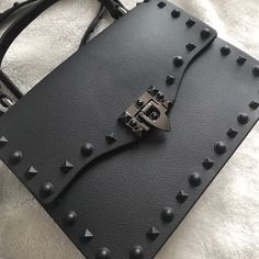 Very Cute Of Stud Purse, Black Color With Matt Finish Detachable Studded Strap. Platinum Hardware And D-Logo Keychain. The Price Is Stable. Two Sizes: Mini And Medium. This Is The Medium Check My Another Listings With Other Sizes/Colors. Thank You. Black Wallet On Chain With Detachable Strap, Luxury Black Bags With Studs, Designer Black Bag With Studs, Black Studded Purse, Black Wallet With Detachable Strap For On-the-go, Studded Purse, Black Purses, Medium Bags, Black Color