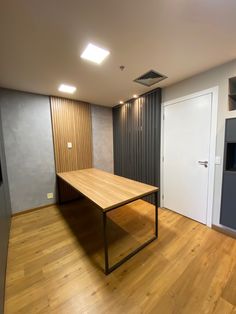 an empty room with a wooden table in it