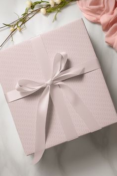 a pink gift box with a bow on it