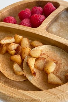 two wooden trays filled with food and raspberries