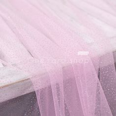 pink tulle with white dots on it