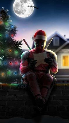 a man sitting on top of a brick wall next to a christmas tree and holding a baseball bat