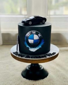 a black cake with a bmw car on top