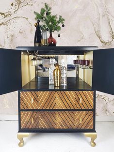 a black and gold dresser with some decorations on top