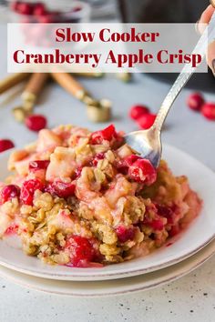 cranberry apple crisp on a white plate with a spoon in it and text overlay reading slow cooker cranberry apple crisp