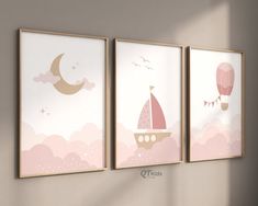 three pink and gold nursery art prints hanging on a wall in a child's room