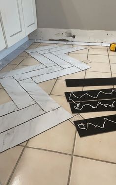 the tile is being laid out on the floor with tools and tape around it to make sure that there are no tiles in the room