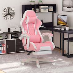 a pink and white office chair sitting in front of a computer desk