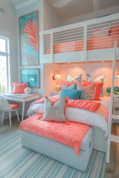 a white bed with orange and blue pillows in a bedroom next to a desk area