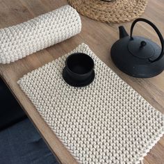 there is a tea pot and mat on the table