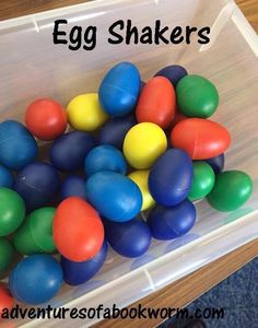 plastic eggs in a bin with the words egg shakers above them and below it