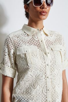 In modern lace, this shirt has a cool vibe. The linen covered button front closure, utility patch pockets & open-work lace make it perfect for warm Spring days. Versatile & chic, wear it with Elie's favorite white or denim jeans, or dressed up with our crepe pants. Elie Tahari Exclusive Short Sleeve Lace Button Down Shirt with Utility Chest Pockets 49% Polyamide, 47% Cotton, 4% Elastane Runs true to size. Model is 5'9" and wearing size S Length From Shoulder to Hem: Back 25.5 "L, Sleeve: 21 "L ( Elevated Essentials, Crepe Pants, Utility Shirt, Lace Button, Warm Spring, Denim And Lace, Elie Tahari, Lace Making, Knit Jacket