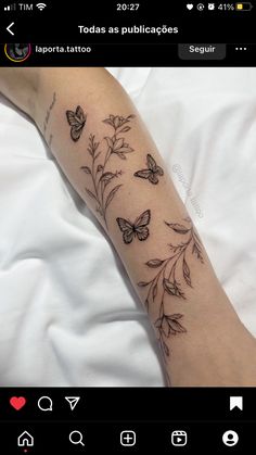 a woman's arm with butterflies on it and flowers in the middle of her arm