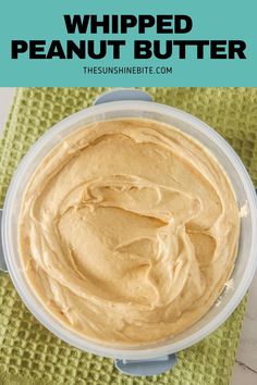 a bowl filled with peanut butter sitting on top of a green towel