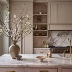 a vase filled with flowers sitting on top of a kitchen counter