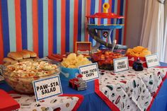 a table topped with lots of food and snacks