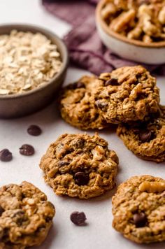 chocolate chip cookies and oatmeal in bowls on a white surface with purple linen