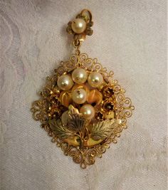 "This is a vintage large filigree gold pin or pendant also can be used as a necklace. All hand made. The appraisal was made in 1980 with other very fine jewelry.  This beautiful gold pendant is large with 7 large pearls. 3\" long by 2\" wide.  The gemologist and appraisal report reads.  7 pearl & gold pin/pendant contains 7 cultured pearls each 6.5 to 7m.m. round dark cream color with medium luster. The mounting is handmade with floral and filigree design of low karat yellow gold with bright gol Beautiful Gold Pendants, Pearl Pin, Gold Pin, Pin Pendant, Pearl Brooch, Filigree Design, Pearl Flower, Vintage Pins, Glass Christmas Ornaments