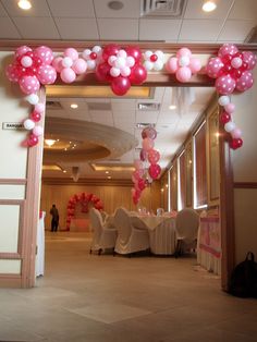 balloons and tables are set up in an empty room for a wedding reception with white linens on the floor