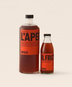 a bottle of liquid sitting next to an empty glass bottle with the label l'ape on it