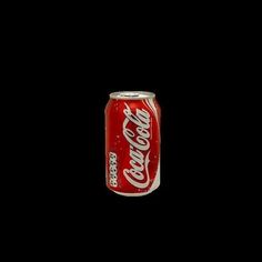 a can of coca cola on a black background