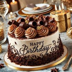 a birthday cake with chocolate frosting and decorations on the top is sitting on a table