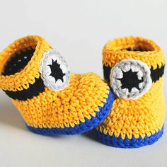 a pair of crocheted yellow and blue baby shoes