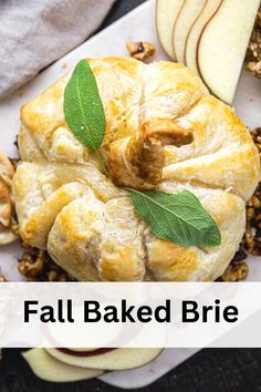 an apple pie with leaves on top and the words fall baked brie above it