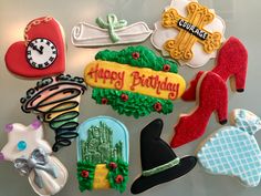 decorated cookies are arranged in the shape of women's shoes, hats, and boots