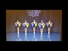 a group of young women standing on top of a stage