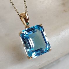 This stunning pendant is set in 14k Solid Yellow Gold with Natural Swiss Blue Topaz with utmost precision. It is a unique gemstone Pendant for nearly every occasion and is completely hassle-free jewelry. ITEM DETAILS: * GEM: Swiss Blue topaz * GEM SIZE: 10x12 mm * GEM SHAPE: Octagon * Gem weight: 6.95 carats * Gold Purity: 14KT (58.33% approx.) * Gold Weight: 1.03 gram * Total Weight of the Pendant: 2.42 gram The Gold purity is guaranteed and it comes with authentic 14KT gold hallmark. Since my items are handmade, they are absolutely nickel and lead free. CUSTOMIZATION: * Gemstone customization is available and it can be substituted with a gem of your choice. Kindly message me for the same. PACKAGING * The Pendant comes with layers of safe and secure wrapping along with Free handmade jewel Lapis Pendant, Handmade Jewelry Box, Octagon Shape, Blue Topaz Pendant, Handmade Jewel, Topaz Pendant, Bezel Pendant, Swiss Blue Topaz, Unique Gemstones