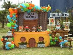 a birthday party with balloons and decorations in the shape of a house, car or boat