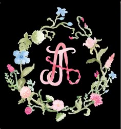 a floral wreath with the letter a in it