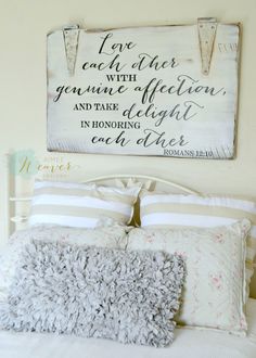 a bed room with a wooden sign above it