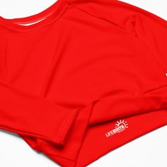 Fall in love with this versatile piece of eye-catching activewear. Our eco-friendly always bright red cropped rash guard –made with recycled polyester and elastane– is the perfect choice for swimming, sports, or athleisure outfits. The long sleeves and cropped cut provides just enough coverage while the UPF 50+ rated material helps block the sun’s harsh UV rays. Stand out in confidence and comfort all year long in our “wear anywhere” cropped top. .: Made with 81% REPREVE recycled polyester, 19% Sporty Red Cropped Tops, Red Moisture-wicking Long-sleeved Activewear, Sporty Fitted Red Crop Top, Sporty Red Crop Top With Crew Neck, Red Fitted Sporty Crop Top, Sporty Red Fitted Crop Top, Red Breathable Tops For Summer, Red Breathable Summer Tops, Red Crop Top For Summer Workout