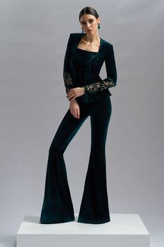 CRISTALLINI VELVET VOGUE pants are a combination of style and comfort, perfect for adding a touch of elegance and sophistication to any outfit.    Velvet flared pants    Hook and fastenings zip on the side    Dry clean    Shown color: Black, Green    Made In EU Luxury Velvet Palazzo Set For Festive Occasions, Luxury Velvet High-waisted Pants, Luxury Elegant Dress Pants For Evening, Luxury Elegant Evening Dress Pants, Luxury Velvet Pants For Fall, Luxury Evening Dress Pants, Luxury Velvet Workwear Bottoms, Luxury Black Flared Dress Pants, Elegant Luxury Evening Flares