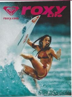 a woman riding a surfboard on top of a wave in the ocean with words roxy