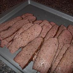 sliced meat on a baking sheet ready to be cooked in the oven for dinner time