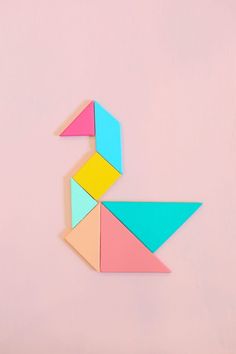 an origami duck on a pink background