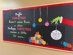 a bulletin board with christmas decorations hanging from it's sides