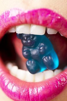 a woman's mouth with gummy bears in it