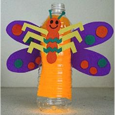 a plastic bottle with a paper cut out of it and a butterfly on the top