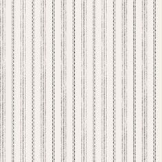 a white and grey striped wallpaper with small black dots on the bottom half of it