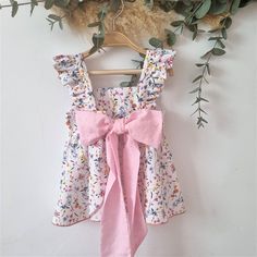 An adorable boho style pink floral organic cotton floral bottom dress with ruffled magas for baby girl to match with a comfy diaper cover with elastic waist and adorable ruffles, an ideal print for this cool outfit for summer or spring. It is the cutest, the perfect gift for toddlers and newborns. Ideal garments for funny moms or to make a very special gift. You will find many assorted items in the shop, it is up to you to compose your own batches! This garment is made of 100% high quality fabri Non-stretch Floral Print Sundress For Spring, Cotton Sundress For Spring, Spring Cotton Sundress, Cotton Sundress For Garden Party In Spring, Fitted Cotton Sundress With Tie Back, Flowy Cotton Sundress For Garden Party, Spring Garden Party Cotton Sundress, Cute Summer Dresses With Ruffle Hem, Cute Summer Dress With Ruffle Hem