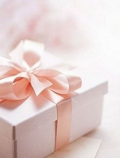 a white gift box with a bow on it