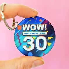 a person holding a keychain with the words wow that's what i call 30 on it