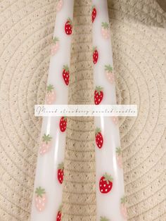 two strawberries and strawberrys on white candles