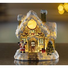 a lighted christmas house with santa and his reindeer