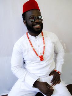 Eze means "King" in Igbo The Eze Traditional Male Coral Beads Necklace provides authentic masculine style infused with historic cowrie shell essence. Handcrafted from coral beads and accented with cowrie shells. This unique design definitely adds authenticity to your wardrobe. This traditional male african coral beads and cowrie shells stand out and is a staple for honoring heritage at Yoruba, Igbo, Benin, and African ceremonies. A meaningful gift for fathers, uncles, brothers or any man who emb White Traditional Beaded Necklaces For Ceremonies, Ceremonial White Necklaces With Round Beads, White Round Beads Necklaces For Traditional Ceremonies, White Round Beads Necklaces For Ceremonial Occasion, White Round Beads Necklace For Ceremonies, White Round Bead Necklaces For Traditional Ceremonies, White Round Bead Necklaces For Ceremonial Occasion, Ceremonial White Handmade Beaded Necklace, Traditional White Beaded Necklaces For Ceremonies