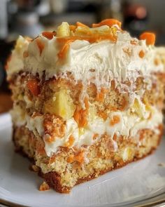 a piece of carrot cake on a plate with white frosting and orange toppings